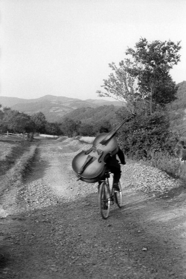 Bass player on the way to play at a village festival Serbia. Henri Cartier-Bresson, 1965